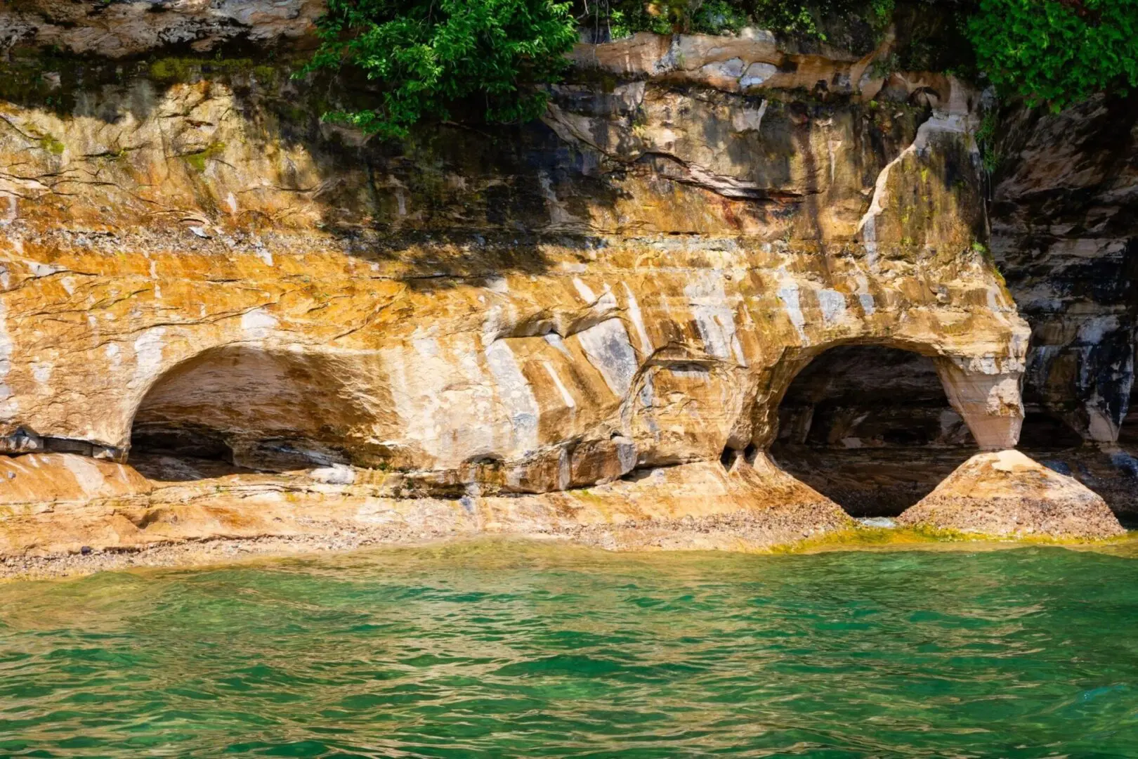 A body of water with rocks and trees in the background.