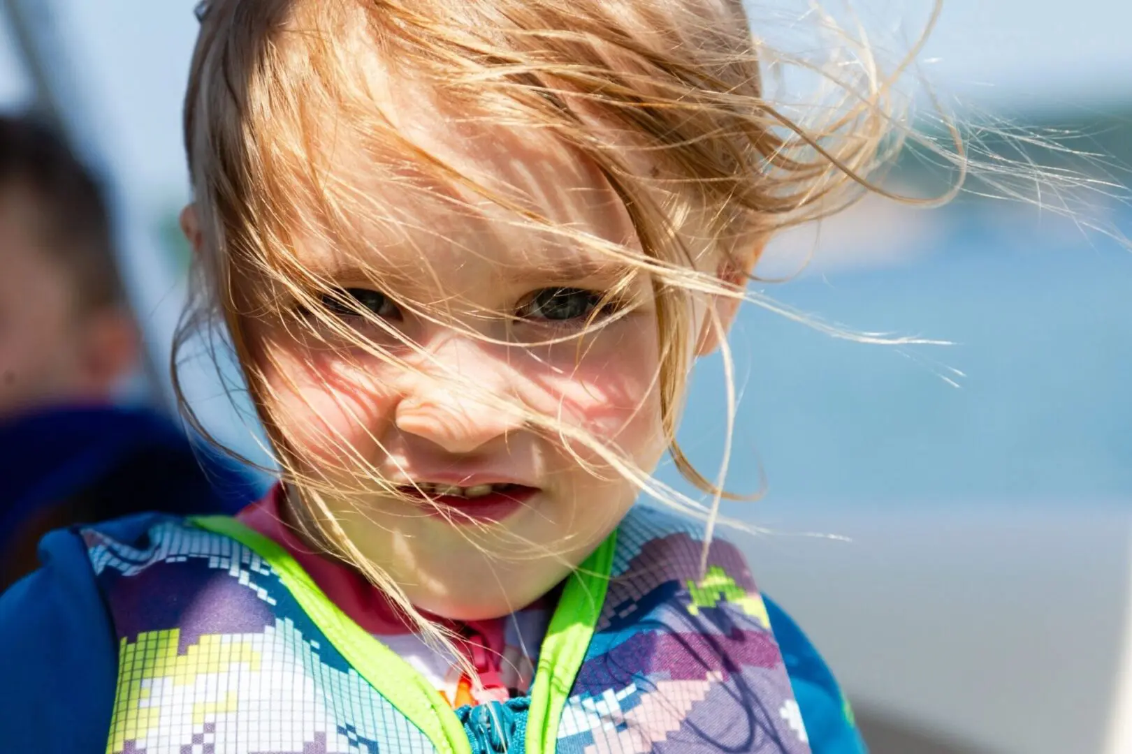 A little girl with blonde hair and blue eyes.