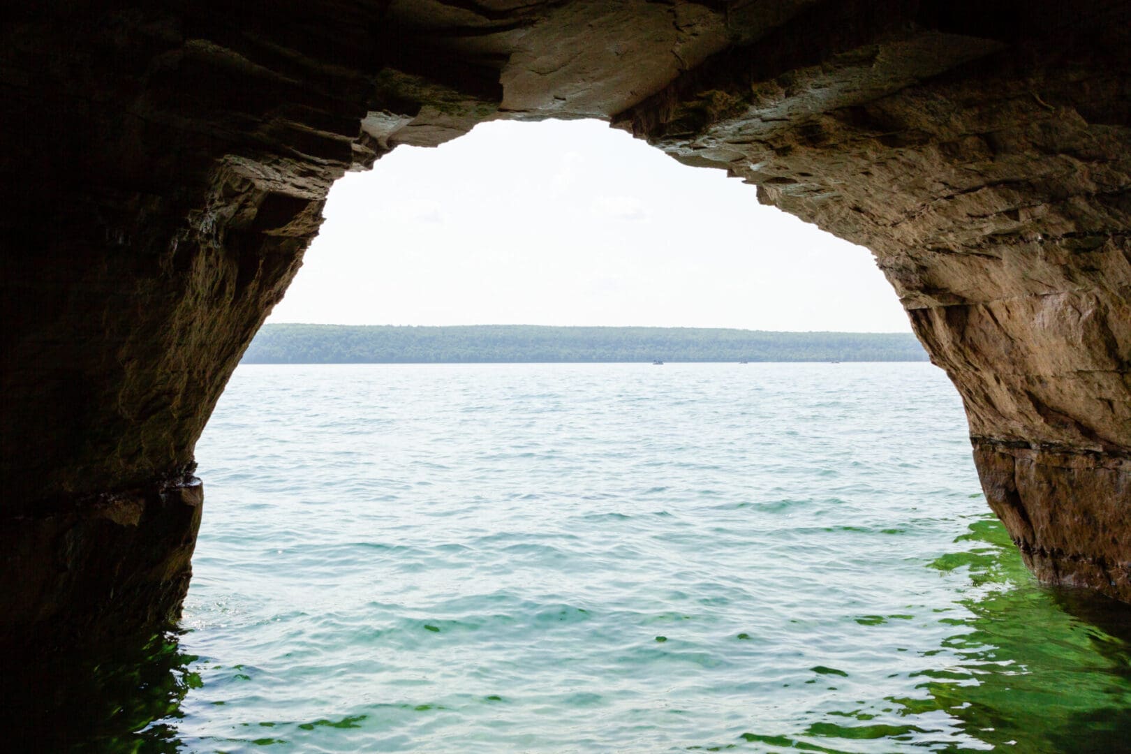 A view of the ocean from inside an arch.