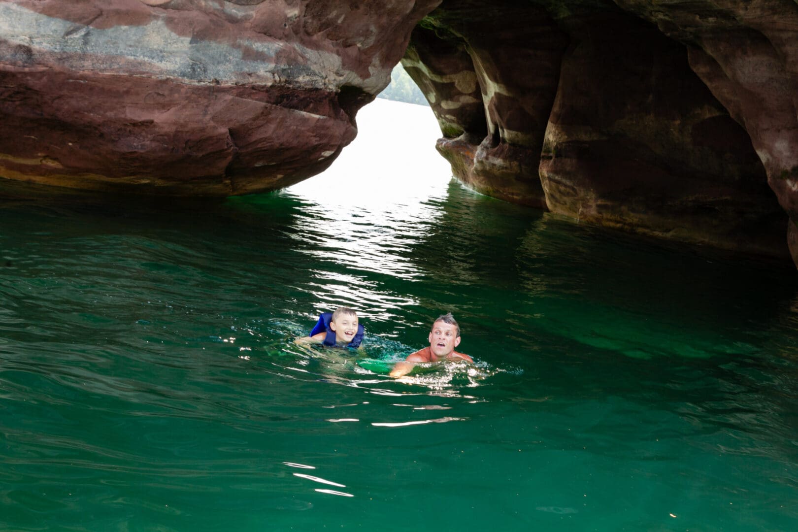 Two people swimming in a body of water