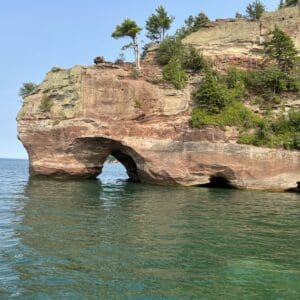 A rock formation with trees on top of it