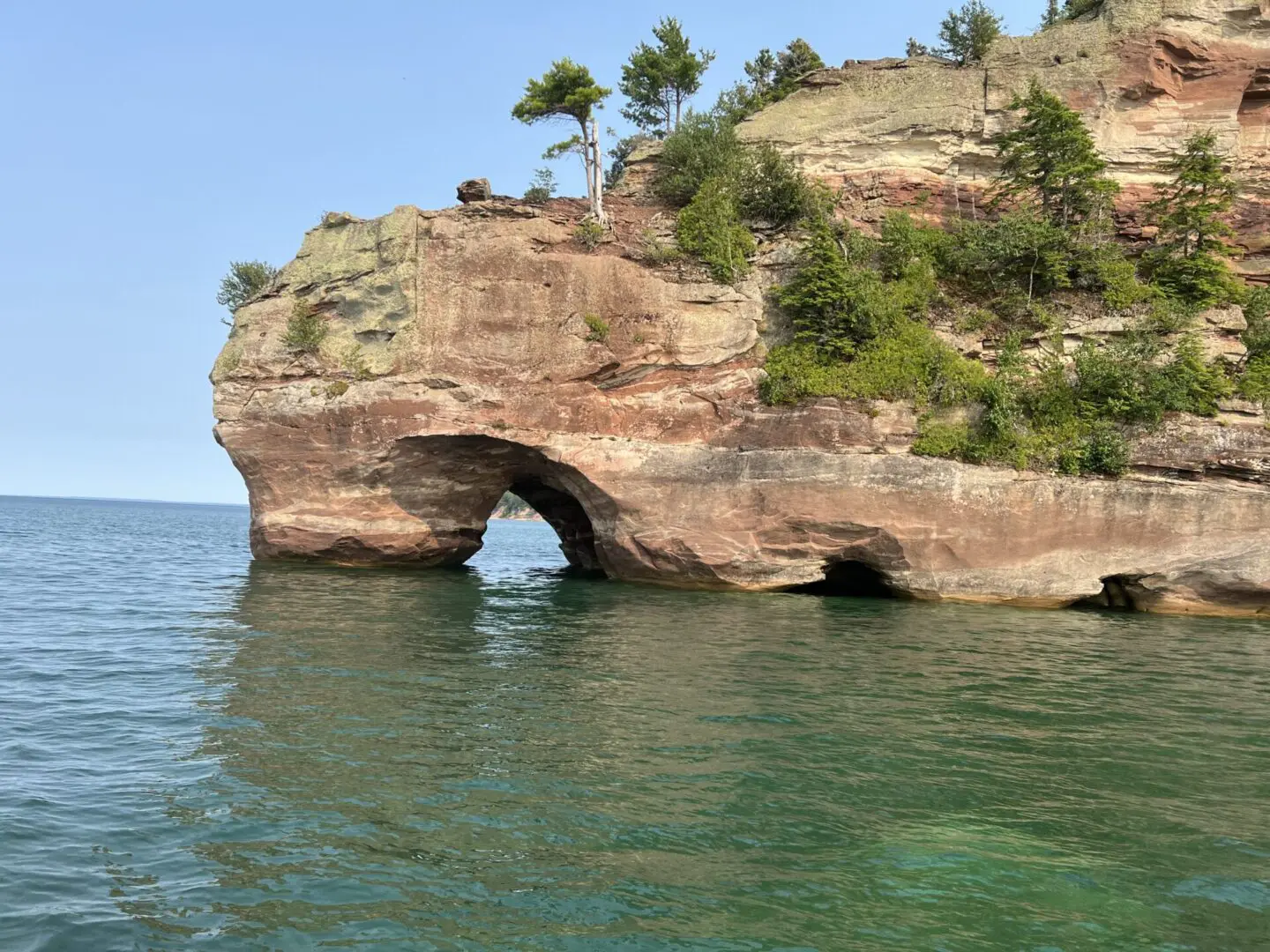 A rock formation with trees on top of it