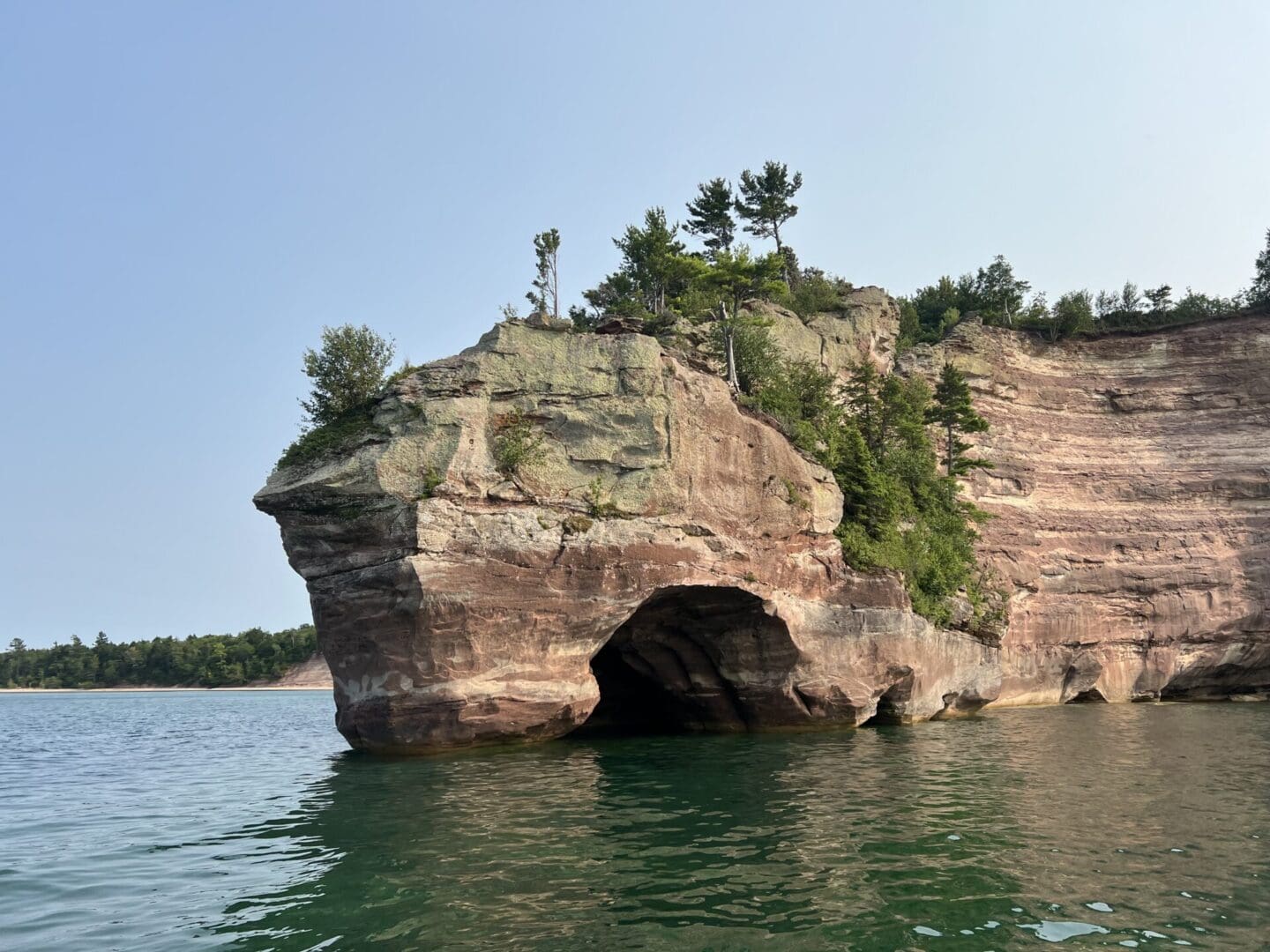 A rock formation with trees on top of it