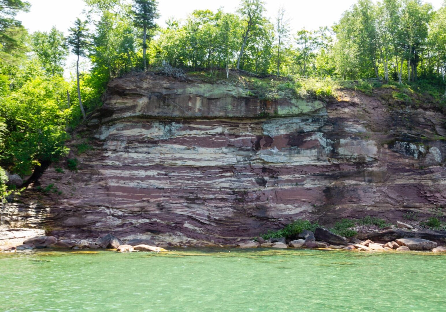 A large rock formation on the side of a cliff.